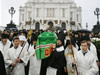 A casket with the body of Russian Orthodox Patriarch Alexy II is carried after a religious procession during a funeral ceremony at Christ the Savior Cathedral in Moscow, Tuesday, Dec. 9, 2008. Candles flickered and white-robed elders chanted prayers as Russia bade farewell Tuesday to Patriarch Alexy II, who guided the country's dominant Russian Orthodox Church through its remarkable recovery after decades of Communist-era oppression. (From AP Photo by STR)